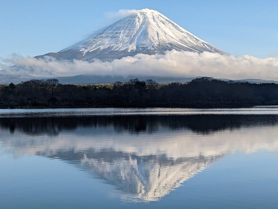 Mount Fuji mirrored in Lake Shojiko on a windless morning, seen from Tatego-hama beach